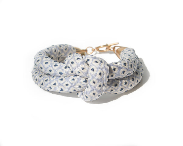 handmade double layer knotted bracelet with brass closure. light blue and white shibori dot silk from a vintage kimono.