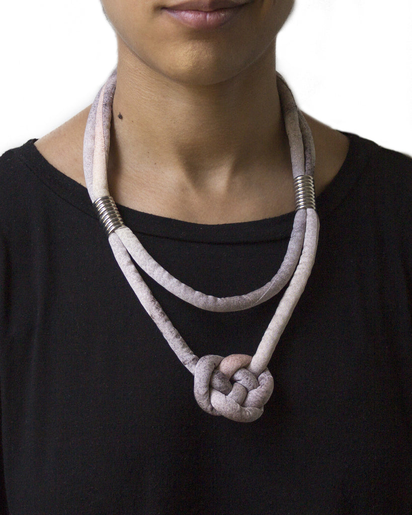 handmade multi strand knotted pendant necklace with silver color beads and brass closure. multi color pastel purple and pink ombre silk. jacquard texture